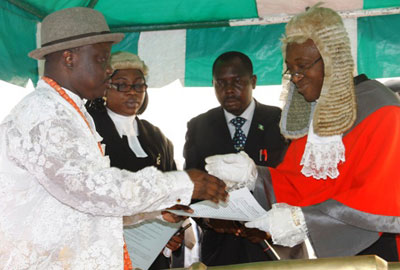 Uduaghan being sworn by the CJ Uduaghan being sworn by the CJ