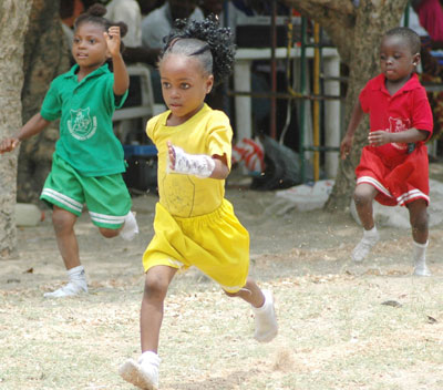 The 18th annual inter-house sports competition of the Olatunde Lawrence Memorial Schools, Nursary and Primary held at the Gaskiya Estate Mini Stadium, Lagos. Ikamt Babatunde of yellow house leading Okpe Sarah of green house and Latifat Ibrahim in the 50m girls event for nursary pupils. Photo by Sylva Eleanya.