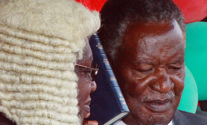Zambia's President Michael Sata (R) takes oath during his swearing-in ceremony at the Supreme Court in Lusaka, on September 23, 2011. Sata took office today, kicking off with a pledge to crack down on the rampant corruption that turned voters away from his predecessor Rupiah Banda. AFP PHOTO
