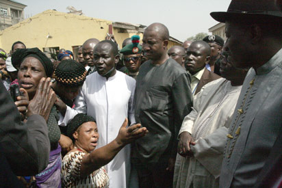 File photo: Nigerian President, Goodluck Jonathan listens to relatives of Christmas bomb blast's victims as he visits the damaged St. Theresa Catholic Church in Madalla on December 31. Photo: AFP