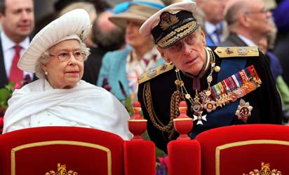 Britain's Queen Elizabeth (L) and Prince Philip, Duke of Edinburgh, standing onboard the Spirit of Chartwell during the Thames Diamond Jubilee Pageant on the River Thames in London. Prince Philip, Queen Elizabeth II's 90-year-old husband, was hospitalised June 4, 2012 with a bladder infection and will miss the rest of her diamond jubilee celebrations, Buckingham Palace said. AFP PHOTO