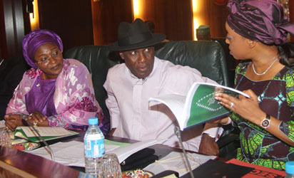 Petroleum Resources Minister, Mrs. Deziani Alison-Madueke (r) showing a copy of the authentic Petroleum Industry Bill to the Niger Delta Minister, Elder Godsday Orubebe and the Minister of State Niger DeltaDevelopment, Hajia Zainab Kuchi while the Sports Minister, Mr. Bolaji Abdullahi watched the weekly meeting of the Federal Executive Council at the State House, Abuja. Photo by Abayomi Adeshida