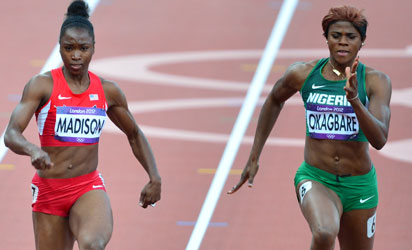 US' Tianna Madison (L) and Nigeria's Blessing Okagbare compete in the women's 100m heats at the athletics event during the London 2012 Olympic Games on August 3, 2012 in London. AFP PHOTO