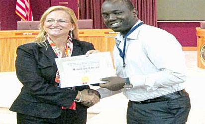 Philip receiving a certificate of honorary citizens from City Council Woman Maren DeWeese of the city of Pensacola, Florida.