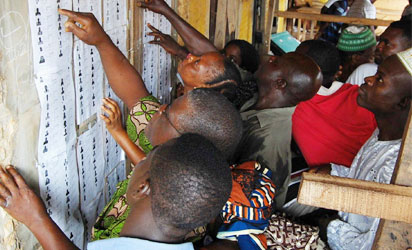 Voters going through the voters list at Ward 5 unit 1 Ijebu, Owo. Photo: Dare Fasube