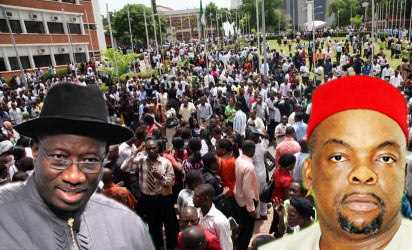 President Jonathan and Emeka Nwogu, Minister of Labour and Productivity. while at the the background job seekers scramble for few job opportunities. - UNEMPLOYMENT