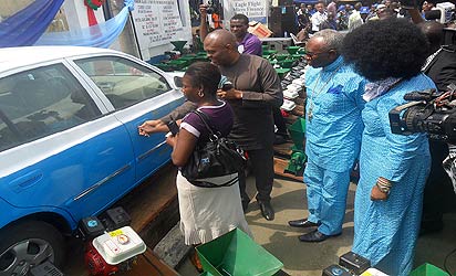 *Chairman of occasion, Mr. Tony Elumelu (2nd l) helping the first winner of a brand new car at the 2012 Word of Life Bible Church/Eagle Flight Micro-Finance Bank poverty alleviation programme, Mrs. Jennifer Tejiri Osatemu (left) to open the car while initiator and CAN president, Pastor Ayo Oritsejafor (2nd r) and wife, Pastor (Mrs.) Helen Oritsejafor (right) watch with keen interest.