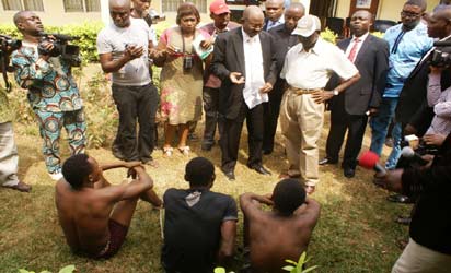 *Suspected Kidnappers on Parade: From right: Governor Adams Oshiomhole of Edo State; Mr. Tukur Bakori, Director of DSS, Edo State, and journalists during the parade of suspected kidnappers in Benin City, Edo State. Photo: Barnabas Uzosike.