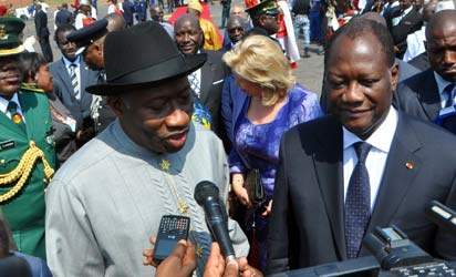 President Goodluck Jonathan (l) addressing newsmen shortly on arrival at the Yamoussoukro International Airport, Cote D'ivoire for the 42nd Ordinary Summit Of Heads Of State and Government of ECOWAS on Wednesday (27/2/12).with him is President Alassane Ouattara of Cote D'ivoire.