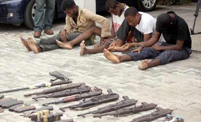 Some suspected robbers and their weapons as paraded by the Rivers State Police in Port Harcourt. Photo: Nwankpa Chijioke.