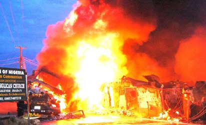 A building burning after a fuel-laden tanker caught fire on Atowoda Street at Inalende in Ibadan, Monday night. Photo: Dare Fasube.