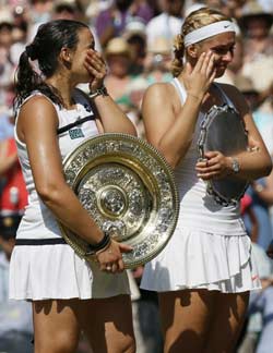 France's Marion Bartoli (L) holds the Venus Rosewater Dish standing next to runner up Germany's Sabine Lisicki (R) during the presentation for their women's singles final match on day twelve of the 2013 Wimbledon Championships tennis tournament at the All England Club in Wimbledon, southwest London, on July 6, 2013. Bartoli won 6-1, 6-4. AFP PHOTO / POOL / STEFAN WERMUTH - RESTRICTED TO EDITORIAL USE