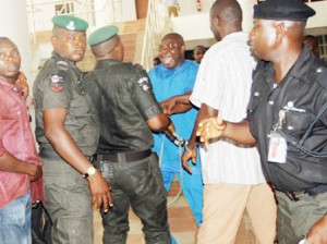 Hon Evan Bapakaye at Loggerheads with a Mobile Police Officer at the Rivers State House of Assembly during the Crisis that Rocked the House. Photo: Nwankpa Chijioke