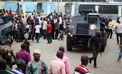 RIVERS—The police fire tear gas as rival lawmakers and their supporters clashed in Port-Harcourt yesterday. Photos: Chijioke Nwankpa.