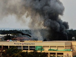 TOPSHOTS
Smoke rises from the Westgate mall in Nairobi on September 23, 2013. Kenyan troops were locked in a fierce firefight with Somali militants inside an upmarket Nairobi shopping mall in a final push to end a siege that has left 43 dead and 200 wounded with an unknown number of hostages still being held. Somalia's Al Qaeda-inspired Shebab rebels said the carnage at the part Israeli-owned complex mall was in retaliation for Kenya's military intervention in Somalia, where African Union troops are battling the Islamists. AFP PHOTO / CARL DE SOUZA
