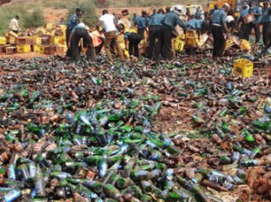 Sharia enforcers called Hisbah destroy thousands of bottles of beer outside northern Nigeria's largest city of Kano on November 27, 2013. The Hisbah destroyed over 240,000 bottles of beer along with over 8,000 litres of local brew called "Burukutu". AFP