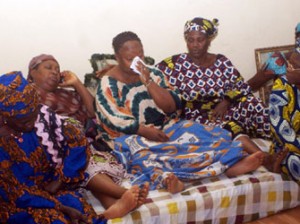 TEARS FOR IYAYI—Relations and sympathisers console Mrs Grace Iyayi (4th L), widow of former president of ASUU, Late Prof. Festus Iyayi at Ekosodin in Benin City. Photo: Barnabas Uzosike.