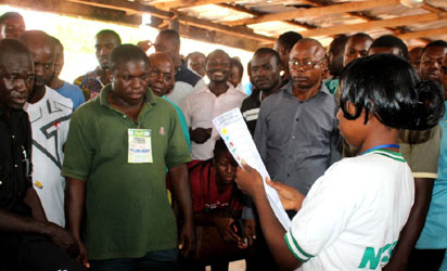 Corper Shobowale Ibironke, Presiding officer, Awka South ward 001 counting result before party agents and voters after voting.