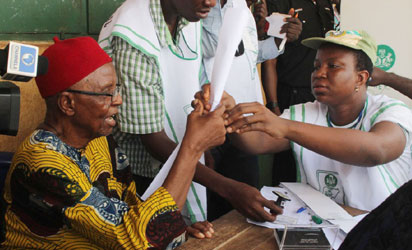 85 year old Chief Michael Iwoba, a pensioner being accredited to vote at Eri Primary School, Aguleri.