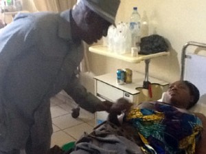 TRAGEDY: Interior Minister, Abba Moro, with one of the victims of Nigeria Immigration Service aptitude test tragedy, at the National Hospital, Abuja, yesterday.