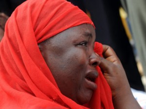 One of the mothers of the missing Chibok school girls wipes her tears as she cries during a rally by civil society groups pressing for the release of the girls in Abuja on May 6, 2014, ahead of World Economic Forum. Members of civil society groups marched through the streets of Abuja and to the Nigerian defence headquarters. AFP