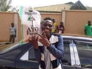 An Ekiti State University student displaying a bag of rice he got from Ayo Fayose