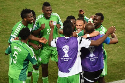 Nigeria's forward Peter Odemwingie (3rd-R) celebrates with teammates after scoring a goal during the Group F football match between Nigeria and Bosnia-Hercegovina at the Pantanal Arena in Cuiaba during the 2014 FIFA World Cup on June 21, 2014. AFP PHOTO /