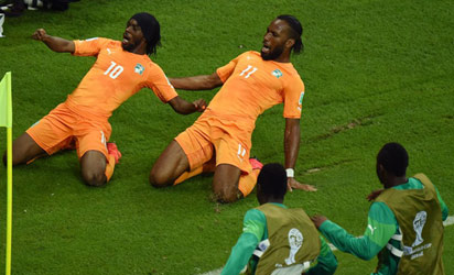 Gervinho of the Ivory Coast (L) celebrates scoring his team's second goal with teammate Didier Drogba during the 2014 FIFA World Cup Brazil Group C match between the Ivory Coast and Japan at Arena Pernambuco on June 14, 2014 in Recife, Brazil. (Photo FIFA)