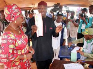 Governorship Candidate, All Progressives Congress, APC, Dr Kayode Fayemi; with his wife, Erelu Bisi Fayemi, on the verge of casting their votes at Ogilolo Ward, Isan-Ekiti... on Saturday.