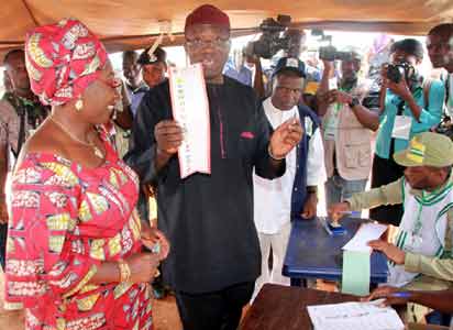 Governorship Candidate, All Progressives Congress, APC, Dr Kayode Fayemi; with his wife, Erelu Bisi Fayemi, on the verge of casting their votes at Ogilolo Ward, Isan-Ekiti... on Saturday.