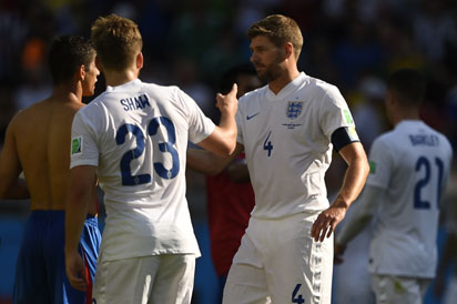 England's midfielder and captain Steven Gerrard (R) shakes hands as England's defender Luke Shaw (C) looks on after the Group D football match between Costa Rica and England at The Mineirao Stadium in Belo Horizonte on June 24, 2014,during the 2014 FIFA World Cup . AFP PHOTO / FABRICE COFFRINI