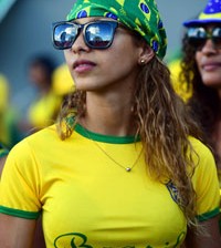 A Brazilian fan watches a live screening of her team's match against Croatia at the Fans Fest in Cuiaba on June 12, 2014, as play of the 2014 FIFA World Cup Group A football match between Brazil and Croatia takes place at the Corinthians Arena in Sao Paulo. AFP PHOTO / MARTIN BERNETTI