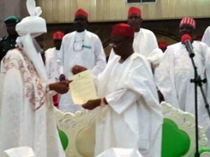 Kwankwaso presenting the appointment letter to the new emir of Kano