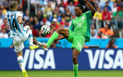 - JUNE 25: Javier Mascherano of Argentina vies with Okechukwu Uchebo of Nigeria during the 2014 FIFA World Cup Brazil Group F match between Nigeria and Argentina at Estadio Beira-Rio on June 25, 2014 in Porto Alegre, Brazil. Photo: FIFIA