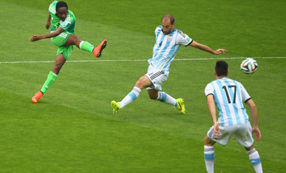 Ahmed Musa of Nigeria shoots and scores his team's first goal against Pablo Zabaleta of Argentina during the 2014 FIFA World Cup Brazil Group F match between Nigeria and Argentina at Estadio Beira-Rio on June 25, 2014 in Porto Alegre, Brazil. (Photo by FIFA)
