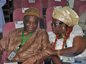 From left, Chief Raymod Dopkesi discussing with Chief Mrs. Sani Felicia on Monday during Consideration of Devolution of Power Committee’s Report at National Confab in Abuja. Photo by Gbemiga Olamikan.