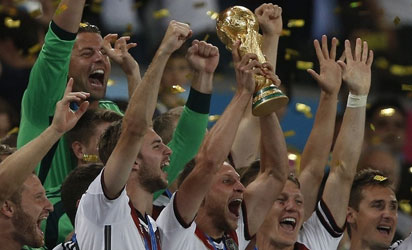WORLD CUP—Germany's forward Andre Schuerrle (C) holds the trophy as he celebrates with teammates after his team's victory in the final football match between Germany and Argentina for the FIFA World Cup at The Maracana Stadium in Rio de Janeiro, . AFP PHOTO.