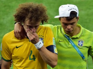 Brazil's defender David Luiz (R) is consoled by Brazil's defender and captain Thiago Silva after losing the semi-final football match between Brazil and Germany at The Mineirao Stadium in Belo Horizonte on July 8, 2014, during the 2014 FIFA World Cup. AFP PHOTO / GABRIEL BOUYS