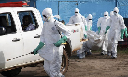 Medical doctors attending to an Ebola virus disease victim