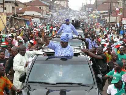 Osun State PDP gubernatorial candidate, Senator Iyiola Omisore and his running mate, Rt. Hon. Adejare Bello acknowledging cheers from supporters during the house-to-house campaign in Ilesa East and West over the weekend.
