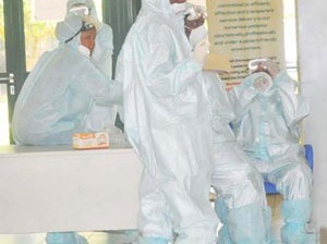 HEALTH PERSONNEL IN PROTECTIVE KITS AT THE NATIONAL HOSPITAL IN ABUJA ON TUESDAY (12/8/14).