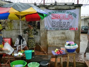 A sign warning of the dangers of ebola outside a government hospital in Freetown on August 13, 2014. The World Health Organisation (WHO) revealed that the latest death toll from the Ebola virus in Guinea, Sierra Leone, Liberia and Nigeria had claimed more than1000 lives. Health Organisations are looking into the possible use of experimental drugs to combat the latest outbreak in West Africa which is also the largest ebola outbreak in history. AFP PHOTO