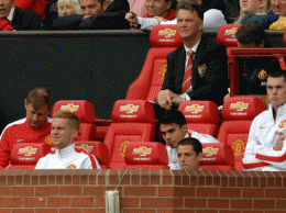Manchester United's Dutch manager Louis Van Gaal watches from the dug out during the English Premier League football match between Manchester United and Swansea City at Old Trafford in Manchester, north west England on August 16, 2014. Swansea City won the game 2-1. AFP PHOTO/PAUL ELLIS