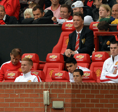 Manchester United's Dutch manager Louis Van Gaal watches from the dug out during the English Premier League football match between Manchester United and Swansea City at Old Trafford in Manchester, north west England on August 16, 2014. Swansea City won the game 2-1. AFP PHOTO/PAUL ELLIS