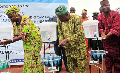 FROM LEFT: MINISTER OF WATER RESOURCES, MRS SARAH OCHEPE; CHAIRMAN, MINI BUS UTAKO PARK, ABUJA, MR OLUGBADE OLAGUNJU AND FCT DEPUTY CHAIRMAN, NATIONAL UNION OF ROAD TRANSPORT WORKERS, ALHAJI GABI IBRAHAM, WASHING THEIR HANDS TO COMMENCE THE NATIONAL EMERGENCY HANDS WASHING CAMPAIGN TO PREVENT THE SPREAD OF EBOLA VIRUS IN NIGERIA AT UTAKO MOTOR PARK IN ABUJA ON MONDAY