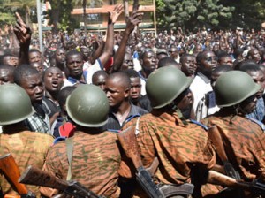 A crowd gathers on October 31, 2014 in front of army headquarters in Ouagadougou, demanding that the army take over following the resignation of the president. Burkina Faso's army chief Navere Honore Traore said he was taking power on October 31 as head of state after President Blaise Compaore announced his resignation as tens of thousands of protesters demanded that he quit immediately after a day of unrest that saw mass protests and the storming of parliament and other public buildings. AFP PHOTO
