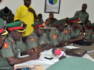 Members of the court martial sit during the inauguration to try soldiers accused of mutiny tasked with fighting Boko Haram militants in Abuja on October 2, 2014. Nearly 100 soldiers tasked with fighting Boko Haram militants in Nigeria's far northeast appeared at a military court martial on Thursday, facing a range of charges including mutiny. The hearing comes just weeks after a tribunal sentenced 12 soldiers to death following their conviction for shooting at their commanding officer in the Borno state capital, Maiduguri, in May. AFP PHOTO