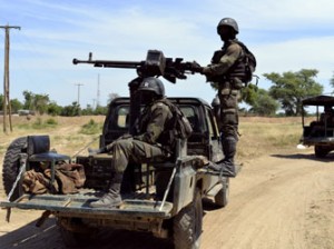File: Cameroonian soldiers patrol on November 12, 2014 in Amchide, northern Cameroon, 1 km from Nigeria. The city was raided by Islamists from Nigeria's Boko Haram, killing eight cameroonian soldiers and leading the population to flee on October 15, 2014, before another six coordinated attacks that killed at least three civilians in the remote north of the country, on November 9, 2014. Boko Haram's five-year insurgency in neighboring Nigeria has left thousands dead, and the Islamists have occasionally carried out attacks over the border. Cameroon has deployed more than 1,000 soldiers in the extreme northeast of the country to counter the Islamist threat. AFP PHOTO