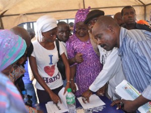 Lagosians checking their names on the INEC list of permanent voters cards (PVC) around 3 pm. at Sunday Adigun polling Unit, Alausa, Ikeja yesterday.