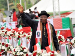 Nigerian President Goodluck Jonathan (R) and Nigerian Vice President Namadi Sambo greet supporters at a ceremony in Abuja on November 11, 2014. Nigeria's President Goodluck Jonathan on November 11 declared his bid for re-election, vowing to finally defeat Boko Haram whose rise in strength during his first term has threatened the country's sovereignty. The 56-year-old made the announcement to tens of thousands of supporters in the red, white and green of his ruling Peoples Democratic Party (PDP), at a carefully orchestrated ceremony including patriotic music, dancing, prayers and speeches. AFP PHOTO